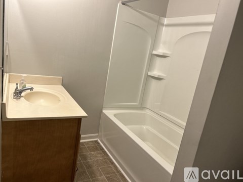A bathroom with a sink, a tub, and a toilet.