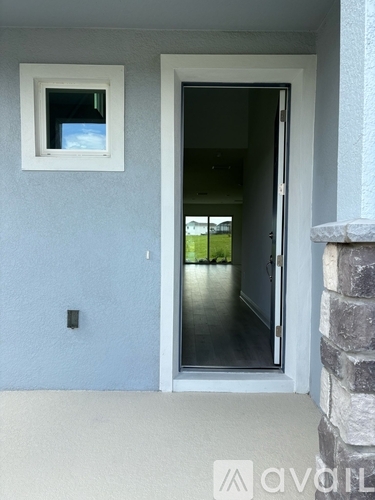 A glass door leads to a grassy area.