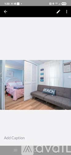 A grey sofa with the word "BEACH" on it.
