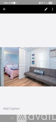 A grey sofa with the word "BEACH" on it.