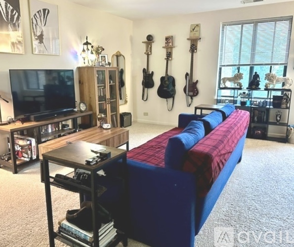 A living room with a blue couch and a television.