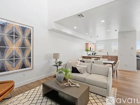 A living room with a white couch and a brown chair.