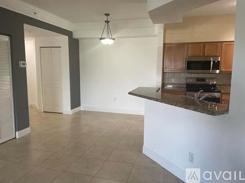 A kitchen area with a counter and a microwave.