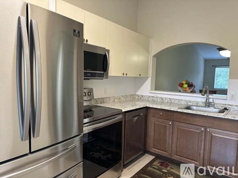 A kitchen with a stainless steel refrigerator and oven.