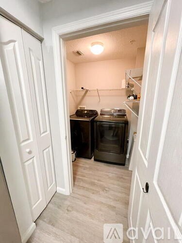 A small kitchen with a stove top oven and a microwave.