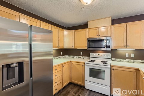 A kitchen with wooden cabinets and stainless steel appliances.