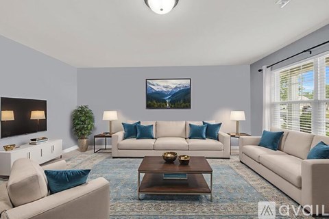A living room with a large painting on the wall and a rug on the floor.