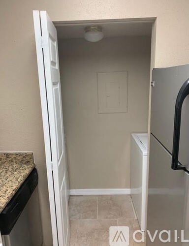 A small white doorway leads to a small bathroom.