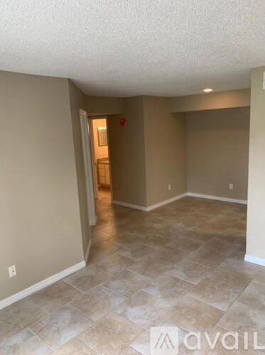 A room with beige walls and a tiled floor.