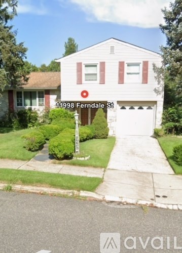 A white house with a red stripe on the front and a sign that says Ferndale St.