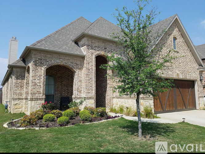 A house with a stone facade and a large front yard.