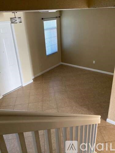 A room with beige walls and a tiled floor.