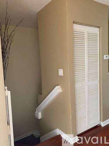 A room with a white door and a white wall.