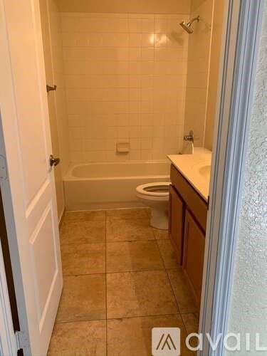 A bathroom with a bathtub, toilet, and sink.