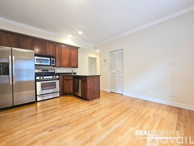 A kitchen with wooden floors and stainless steel appliances.