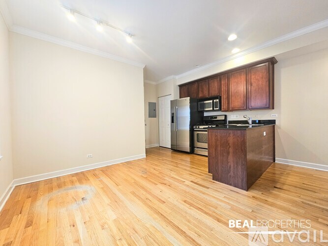 A kitchen with wooden floors and a refrigerator.