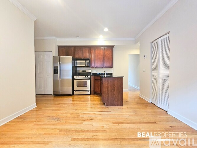A kitchen with wooden floors and white walls.
