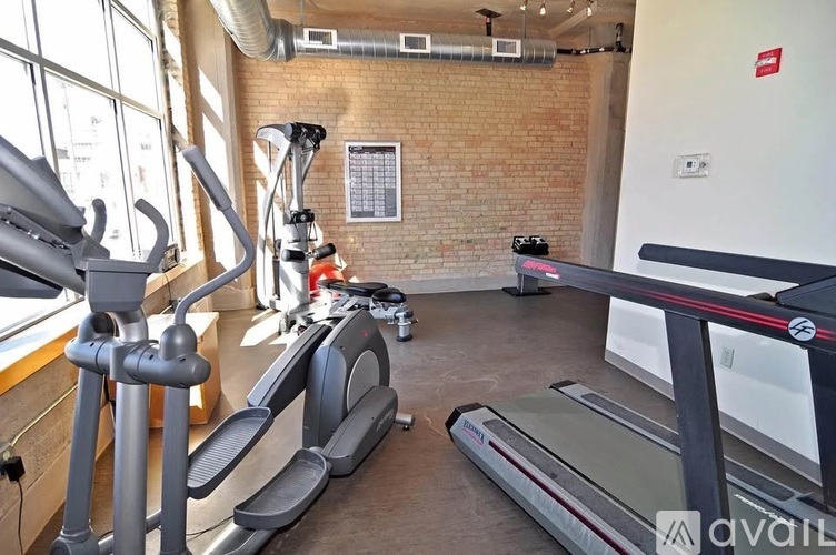 A gym with treadmills, elliptical machines, and other exercise equipment.