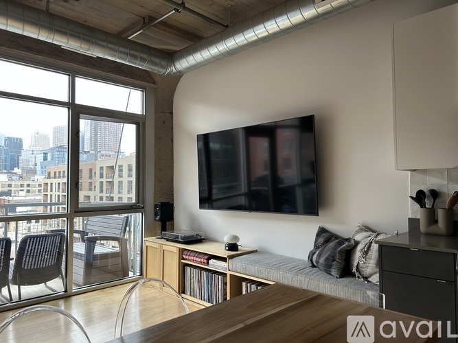 A modern living room with a flat screen TV mounted on the wall.