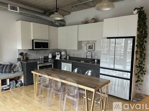 A modern kitchen with a wooden table and chairs.