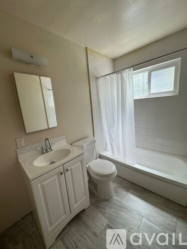 A bathroom with a sink, toilet, and bathtub.