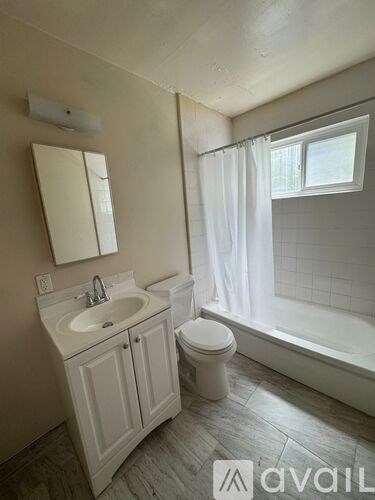 A bathroom with a sink, toilet, and bathtub.
