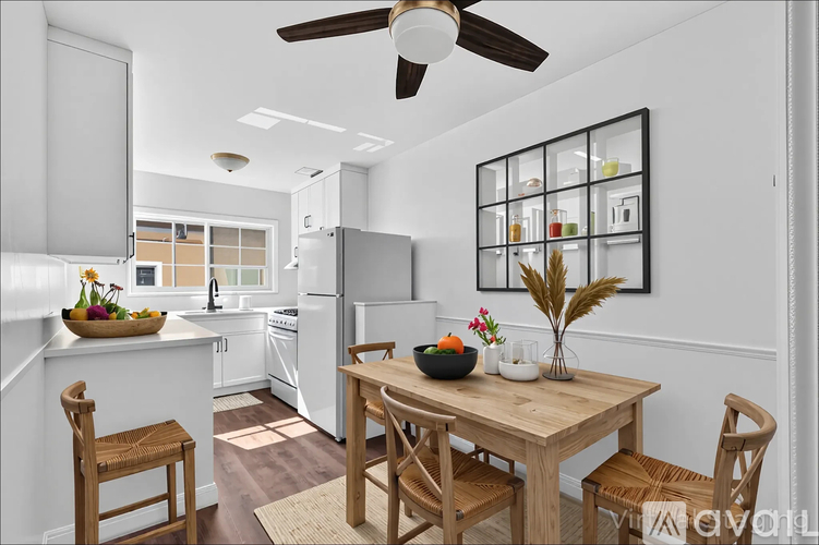 A room with wooden floors and three doors.