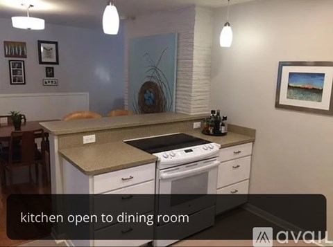 A kitchen with a stove and a dining table.
