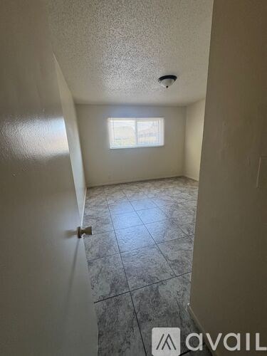 A room with a tiled floor and a window.