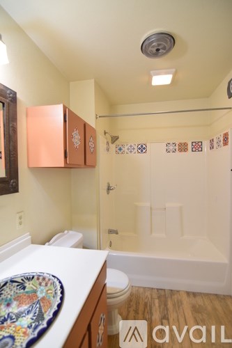 A bathroom with a toilet, sink, and bathtub.