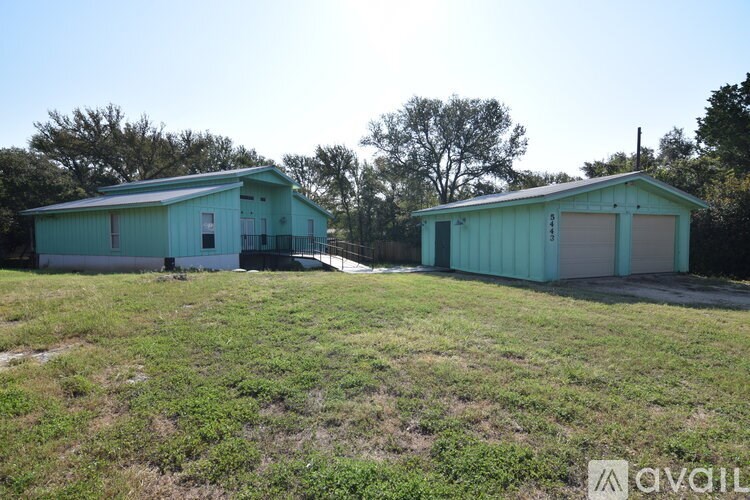 A room with a wooden cabinet and a blackboard on the wall.