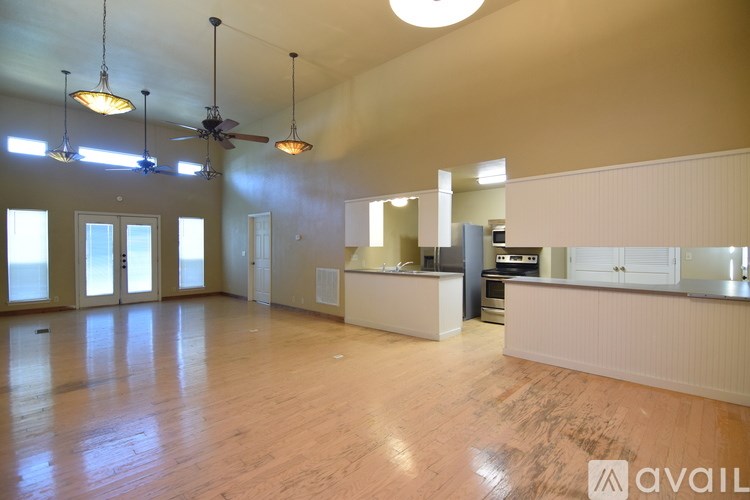 A bathroom with a sink, mirror, toilet and shower.