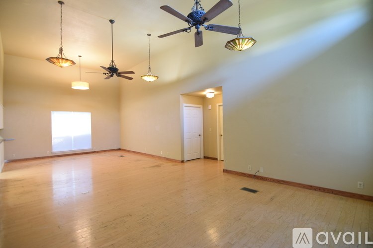 A green house with a tree in front of it.