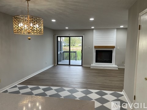 A hallway with a staircase and a door.