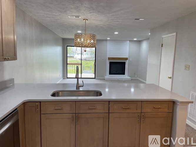 A kitchen with wooden cabinets and a white countertop.