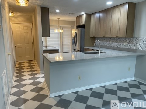 A kitchen with a refrigerator, microwave, oven, and cabinets.