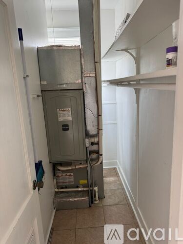 A dirty kitchen with a refrigerator and a wall-mounted oven.