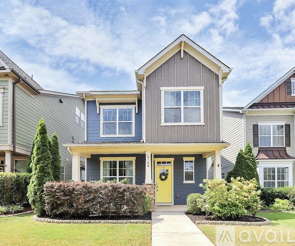 A house with a yellow door is for sale.