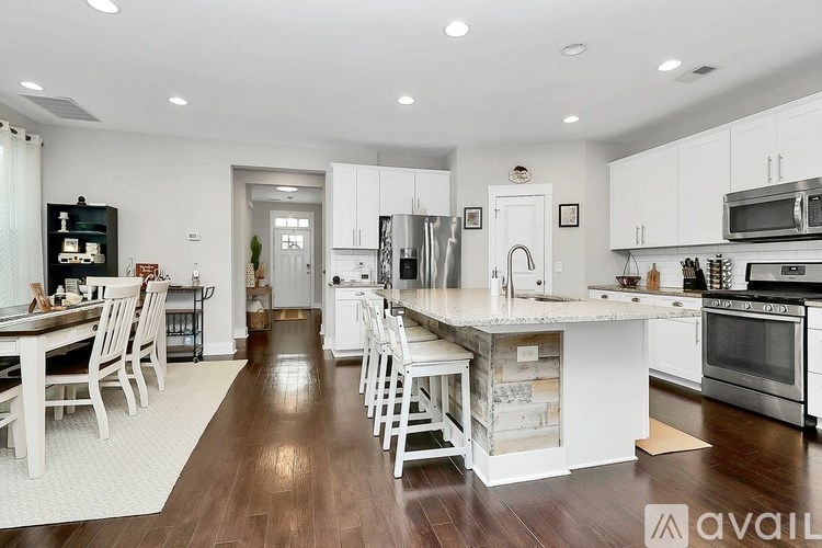 A modern kitchen with white cabinets and a central island.