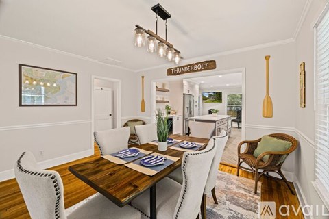A dining room with a wooden table and chairs.