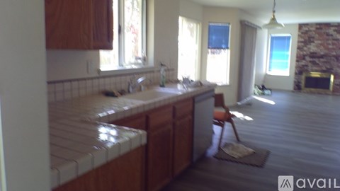 A kitchen with wooden cabinets and a tiled countertop.