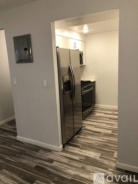 A kitchen with a refrigerator and oven built into the wall.
