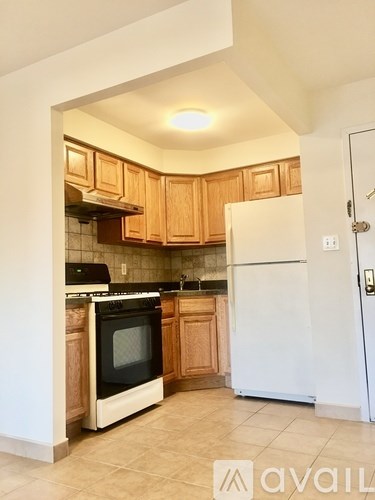 A kitchen with wooden cabinets and a white refrigerator.