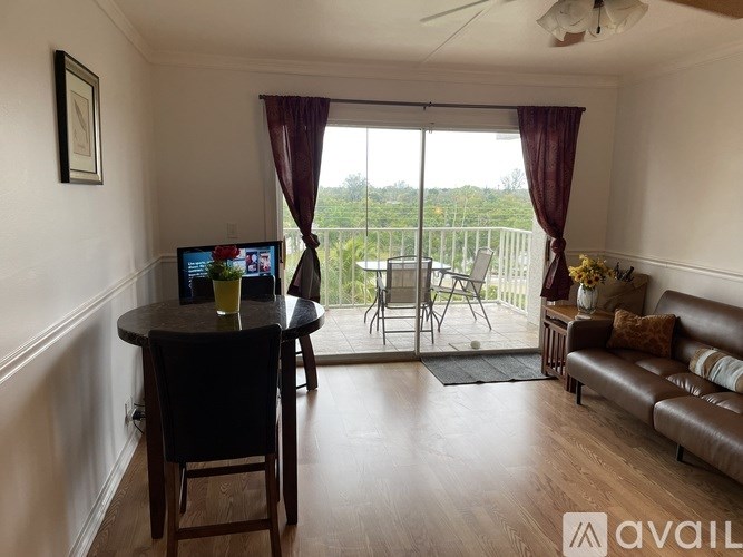 A living room with a table, chairs, and a television.