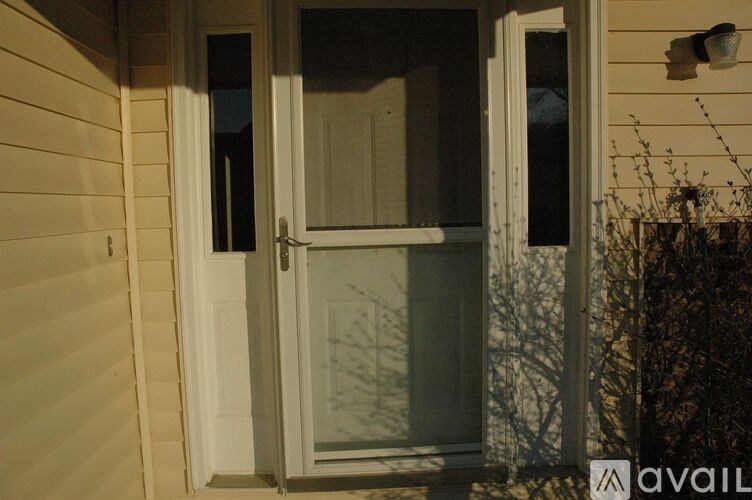 A white door with a glass panel is open.