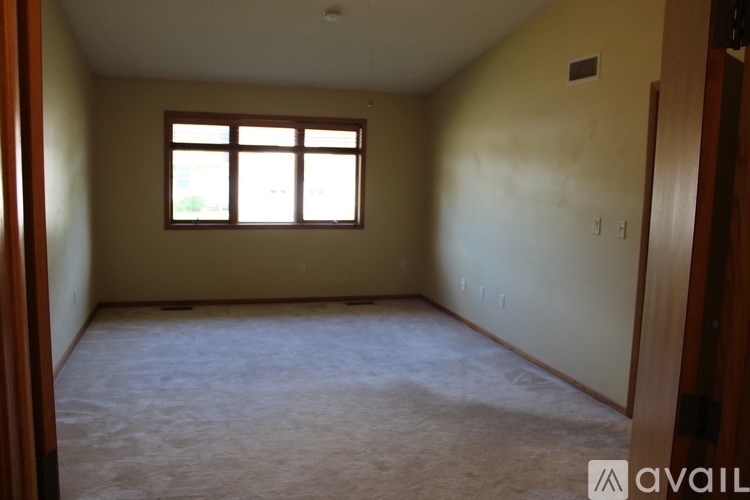 Empty room with a window and a door.