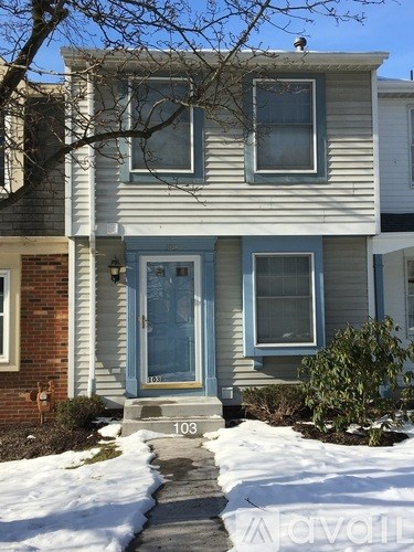 House number 103 has a blue door and steps leading to the front door.