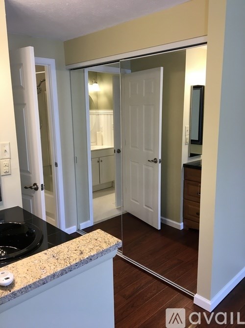 A bathroom with a sink and a mirror.