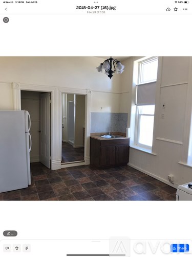 A kitchen with a white refrigerator and a brown countertop.