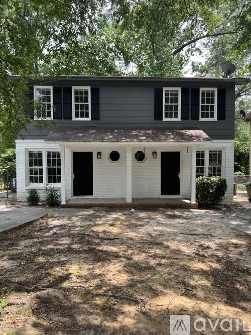 A two-story house with a grey exterior and white trim.